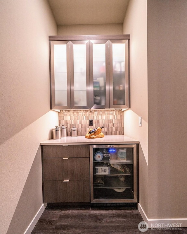 5469 Wood Duck Loop, Blaine, WA 98230 - indoor dry bar with beverage cooler, backsplash, dark wood-type flooring, and baseboards