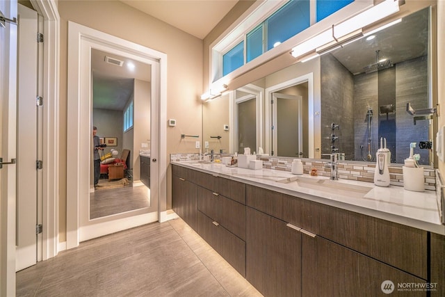 5469 Wood Duck Loop, Blaine, WA 98230 - bathroom featuring double vanity, a tile shower, wood finished floors, and baseboards