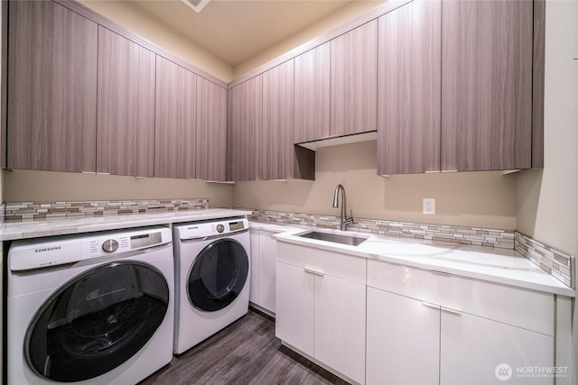 5469 Wood Duck Loop, Blaine, WA 98230 - washroom with washer and clothes dryer, cabinet space, and dark wood-style floors