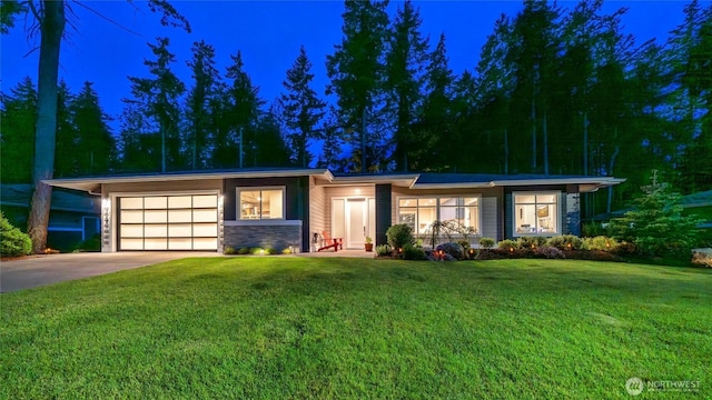 5469 Wood Duck Loop, Blaine, WA 98230 - view of front of property featuring driveway, an attached garage, stone siding, and a lawn