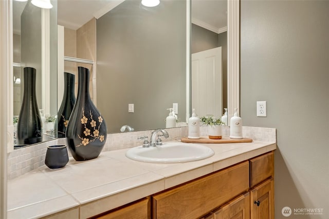 bathroom with vanity and ornamental molding