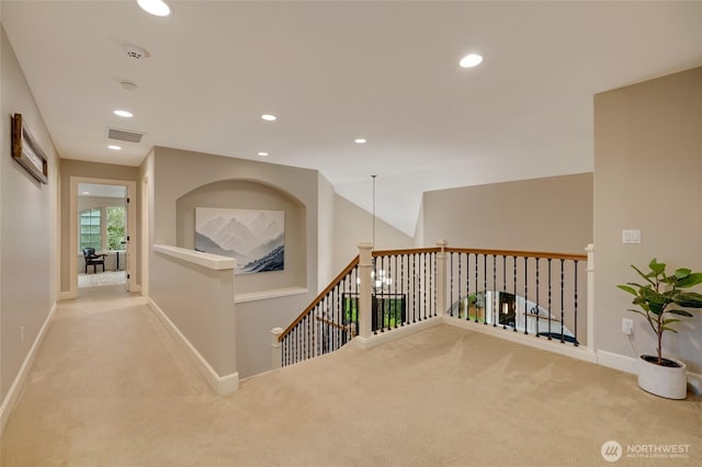 corridor featuring visible vents, baseboards, an upstairs landing, carpet, and recessed lighting