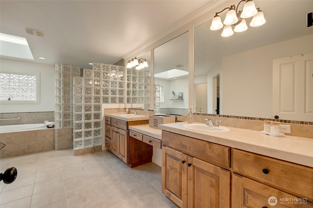 bathroom with a garden tub, vanity, visible vents, a skylight, and tile patterned floors