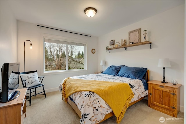 bedroom featuring baseboards and light colored carpet