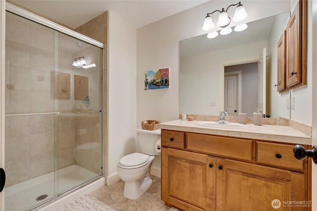 full bath with toilet, a stall shower, vanity, and tile patterned floors