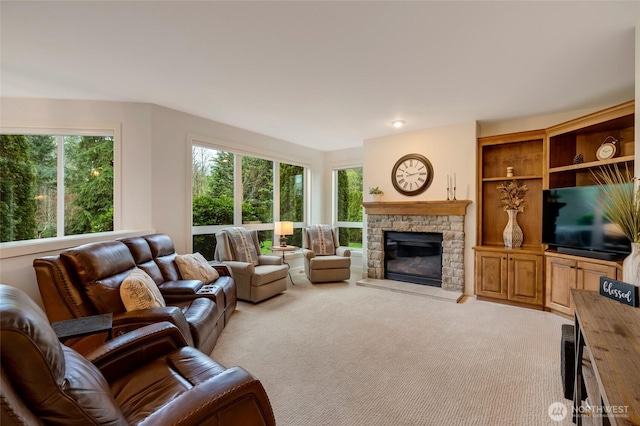 living area featuring light carpet and a fireplace