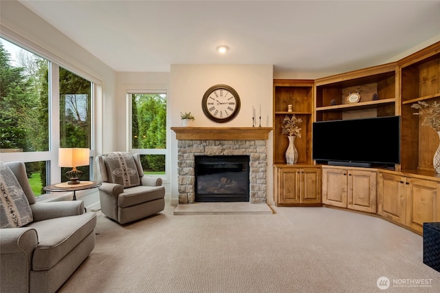 living area featuring light colored carpet and a fireplace