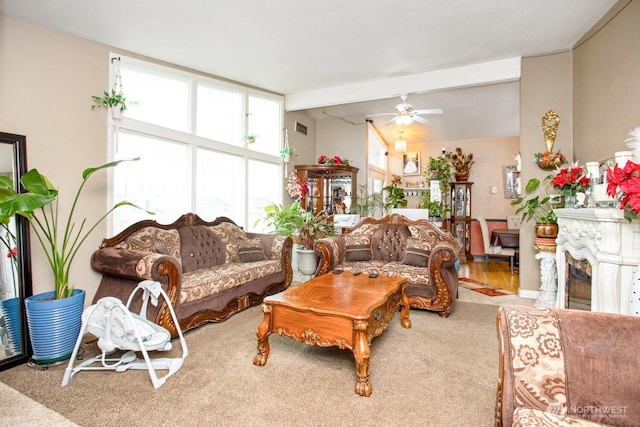 1444 SE Central Ave, College Place, WA 99324 - carpeted living area with vaulted ceiling with beams, a fireplace, visible vents, and a ceiling fan