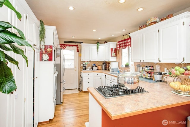 1444 SE Central Ave, College Place, WA 99324 - kitchen with white cabinetry, appliances with stainless steel finishes, and a healthy amount of sunlight