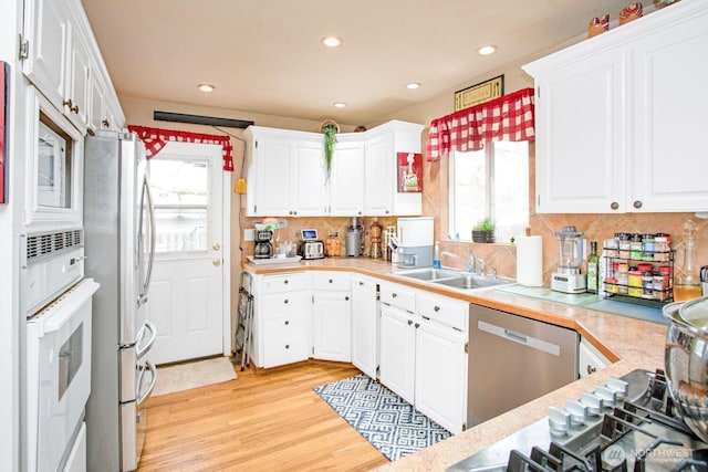 1444 SE Central Ave, College Place, WA 99324 - kitchen featuring appliances with stainless steel finishes, a wealth of natural light, light countertops, and a sink