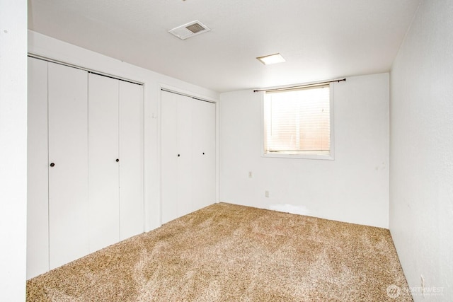 1444 SE Central Ave, College Place, WA 99324 - unfurnished bedroom with carpet flooring, multiple closets, and visible vents