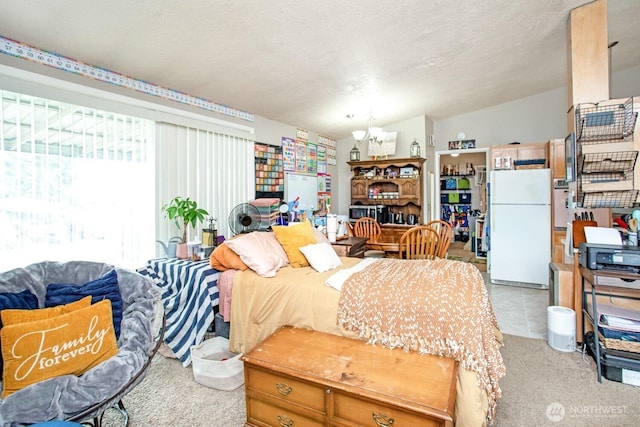 1444 SE Central Ave, College Place, WA 99324 - bedroom featuring vaulted ceiling, a textured ceiling, light carpet, freestanding refrigerator, and a notable chandelier