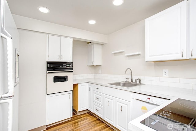 1444 SE Central Ave, College Place, WA 99324 - kitchen with white cabinetry, recessed lighting, white appliances, a sink, and light wood-style flooring