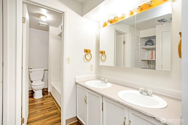 1444 SE Central Ave, College Place, WA 99324 - bathroom featuring double vanity, a sink, toilet, and wood finished floors