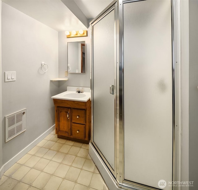 full bathroom with vanity, baseboards, a stall shower, tile patterned floors, and heating unit