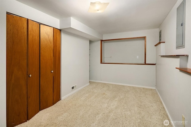 unfurnished bedroom with a closet, electric panel, visible vents, carpet flooring, and baseboards