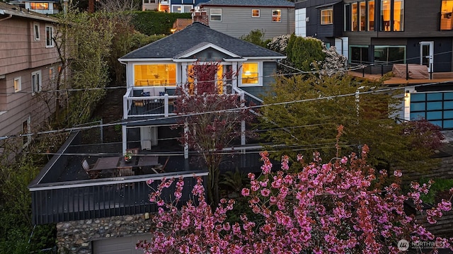 exterior space with roof with shingles