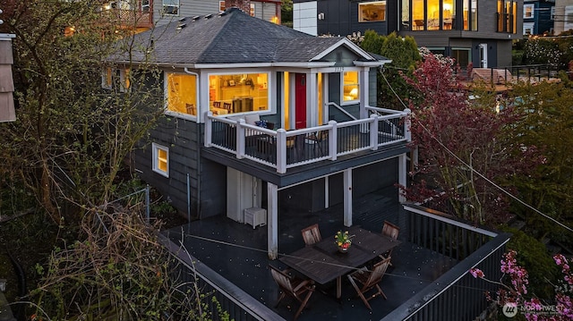 back of property featuring roof with shingles