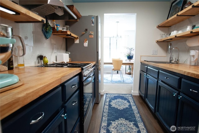 kitchen featuring wood counters, blue cabinets, gas range, and open shelves