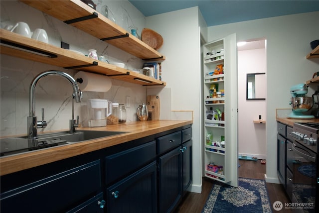 kitchen featuring butcher block countertops, dark wood-style floors, range with electric cooktop, and open shelves