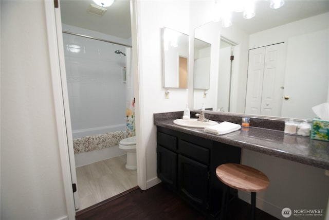 full bathroom with toilet, vanity, shower / tub combo, and wood finished floors