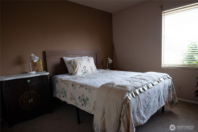 carpeted bedroom featuring baseboards