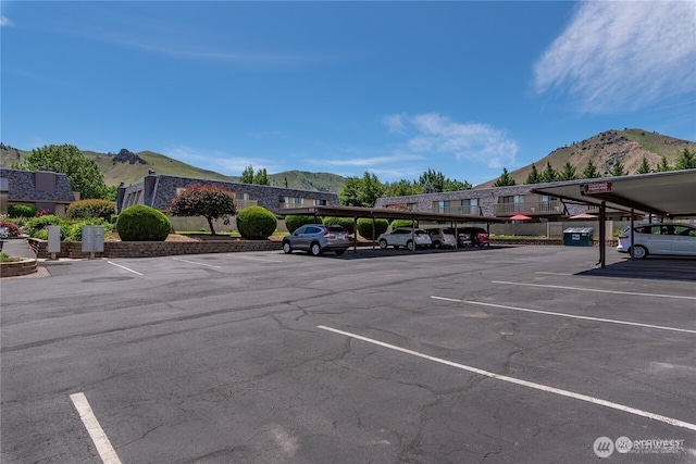 partially covered parking lot with a mountain view