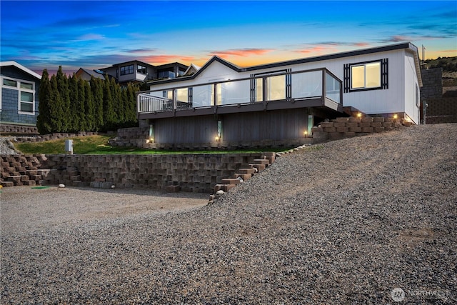 exterior space featuring stairs and a wooden deck