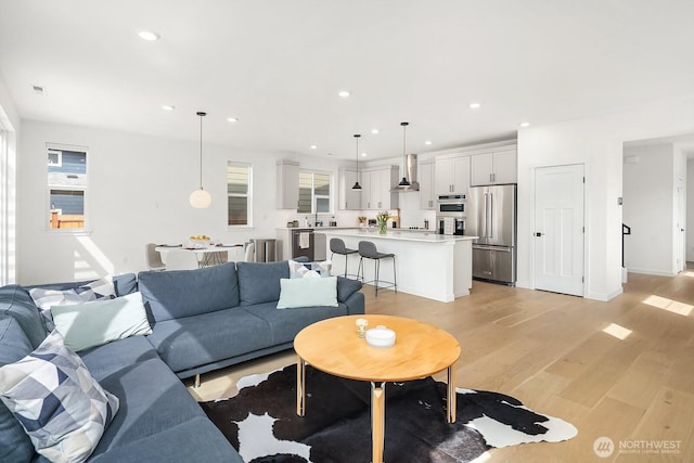 27215 106th Ave SE, Kent, WA 98030 - living room featuring recessed lighting, light wood-type flooring, and baseboards