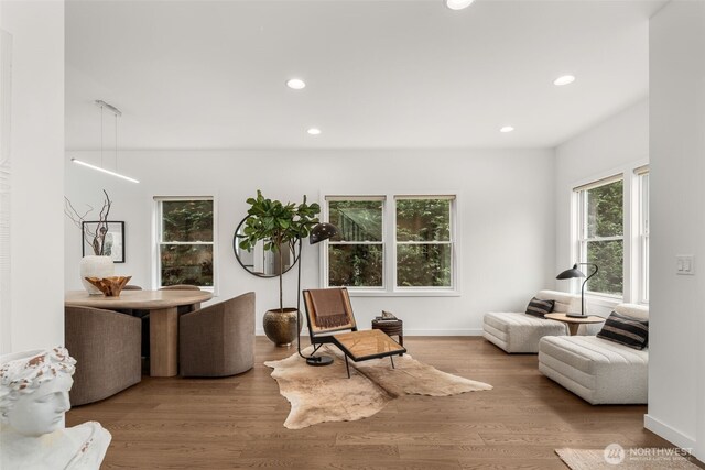 living area with recessed lighting, wood finished floors, and baseboards