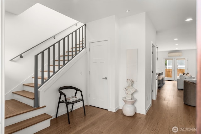 stairway featuring a wall mounted air conditioner, wood finished floors, recessed lighting, and baseboards