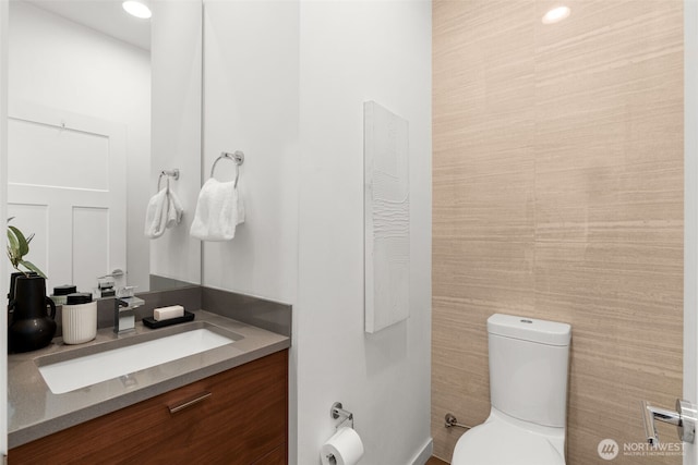 bathroom featuring toilet and vanity