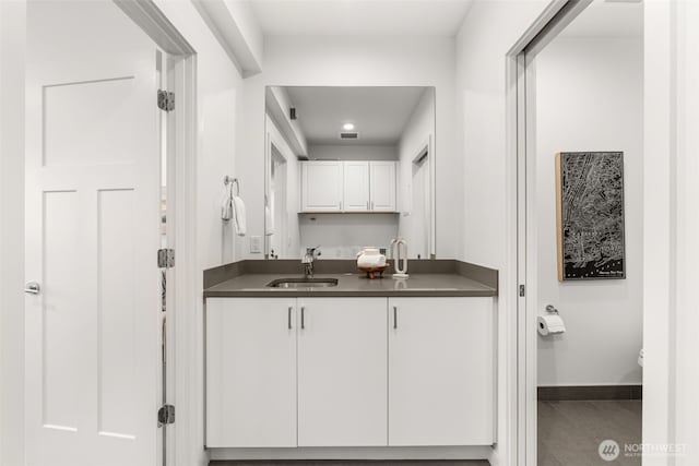 bathroom featuring vanity, tile patterned floors, baseboards, and toilet