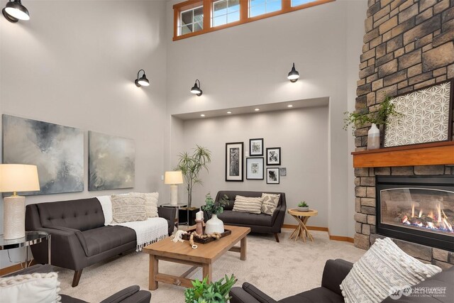 25935 SE 235th Way, Maple Valley, WA 98038 - living room featuring a high ceiling, carpet flooring, a fireplace, and baseboards