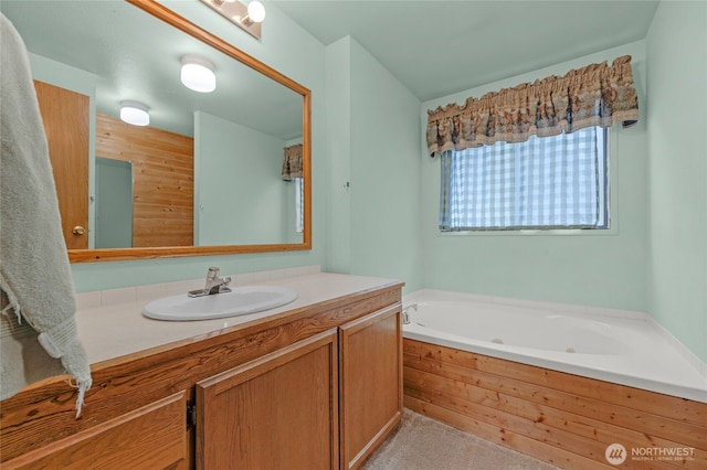 full bath featuring vanity and a tub with jets