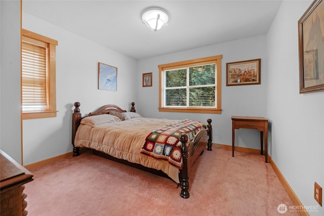 bedroom featuring light colored carpet and baseboards