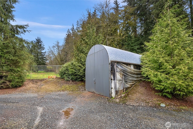 view of shed featuring fence