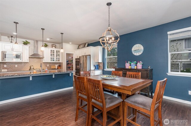 27631 154th Pl SE, Kent, WA 98042 - dining area with a notable chandelier, dark wood-type flooring, and baseboards