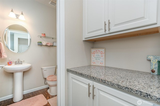 27631 154th Pl SE, Kent, WA 98042 - bathroom with toilet, baseboards, a sink, visible vents, and wood finished floors