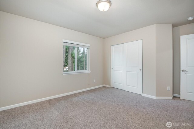 27631 154th Pl SE, Kent, WA 98042 - unfurnished bedroom featuring light carpet, baseboards, and a closet