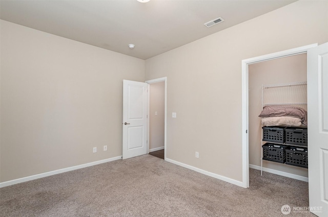27631 154th Pl SE, Kent, WA 98042 - unfurnished bedroom featuring a spacious closet, carpet floors, baseboards, and visible vents