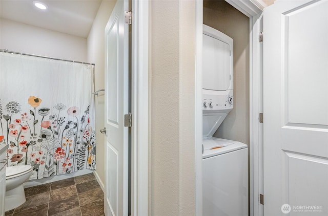 27631 154th Pl SE, Kent, WA 98042 - laundry area featuring stacked washer and clothes dryer, stone finish floor, and laundry area