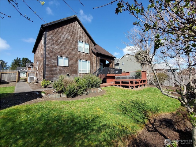 back of property featuring cooling unit, a lawn, fence, and a wooden deck