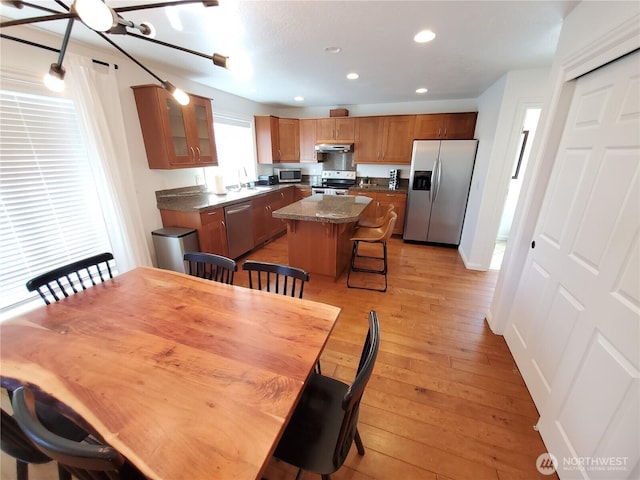 dining area featuring light wood finished floors and recessed lighting