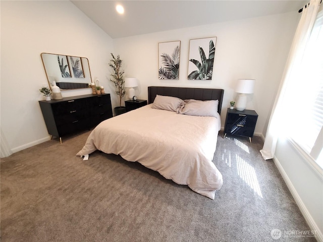 bedroom with baseboards, lofted ceiling, and carpet flooring