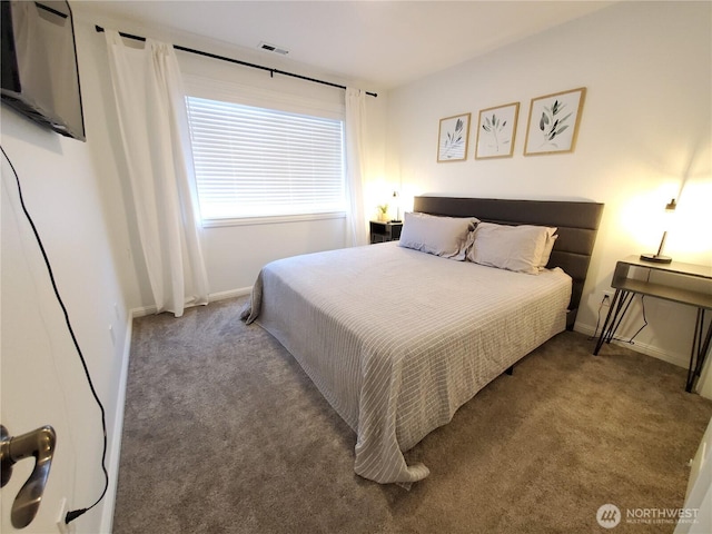 carpeted bedroom featuring baseboards and visible vents