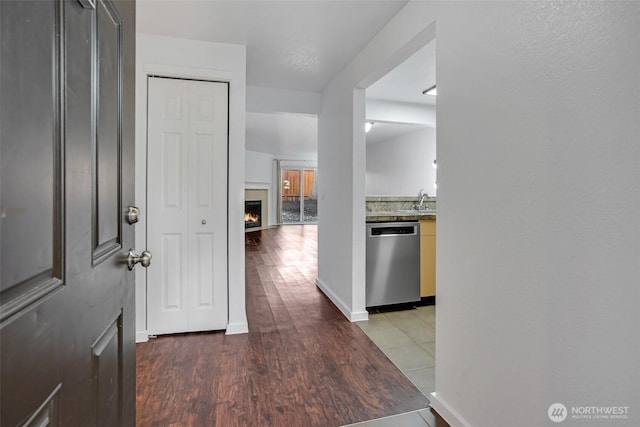 12519 SE 41st Pl Unit B103, Bellevue, WA 98006 - corridor featuring baseboards, a sink, and wood finished floors