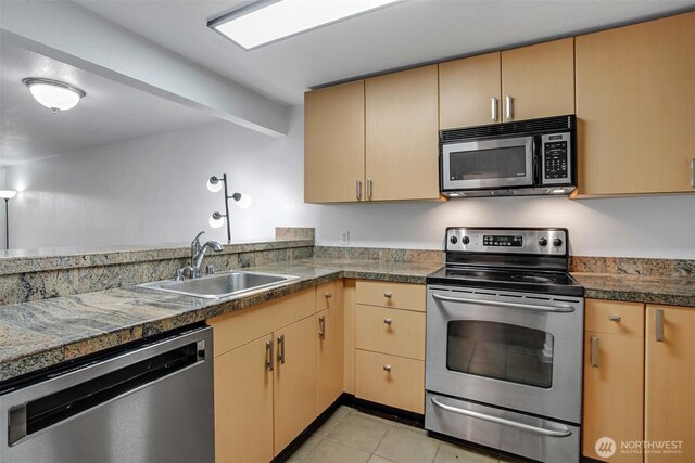 12519 SE 41st Pl Unit B103, Bellevue, WA 98006 - kitchen with light brown cabinetry, appliances with stainless steel finishes, light tile patterned flooring, a sink, and tile counters