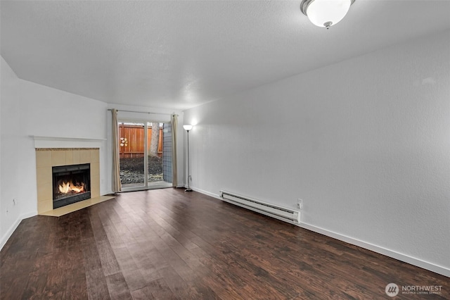 12519 SE 41st Pl Unit B103, Bellevue, WA 98006 - unfurnished living room with a tile fireplace, baseboard heating, baseboards, and wood finished floors