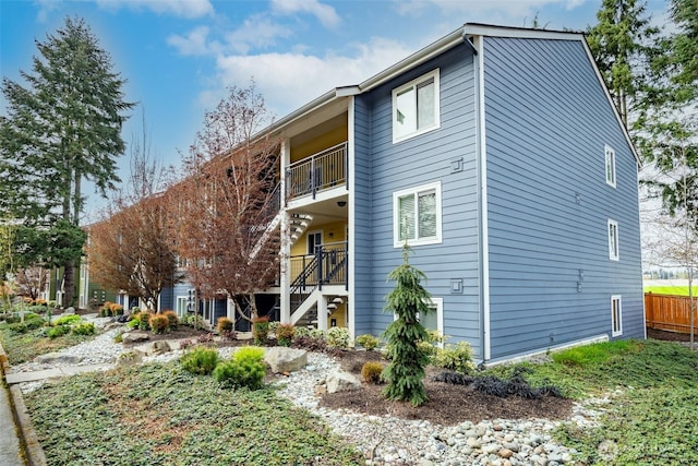 12519 SE 41st Pl Unit B103, Bellevue, WA 98006 - back of house with stairs, a balcony, and fence